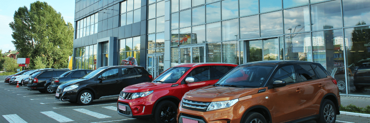 Photo of cars parked outside of a dealership